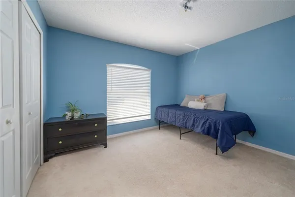 a bedroom with a bed and window