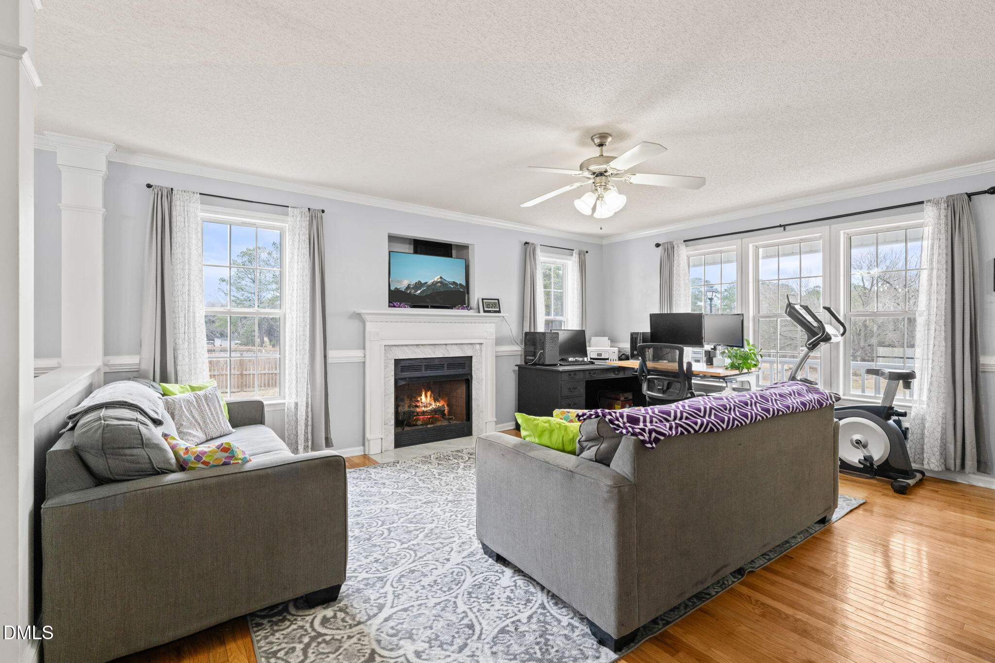 16 Saddle Ridge Drive Willow Spring, NC 27592 - Photo 11 of 57 a living room with furniture a fireplace and a large window