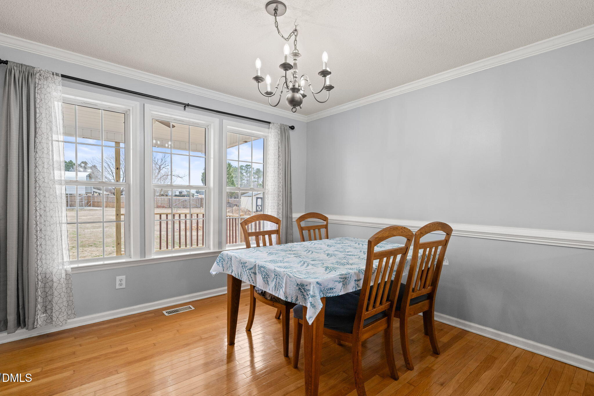 16 Saddle Ridge Drive Willow Spring, NC 27592 - Photo 12 of 57 a view of a dining room with furniture a chandelier and wooden floor