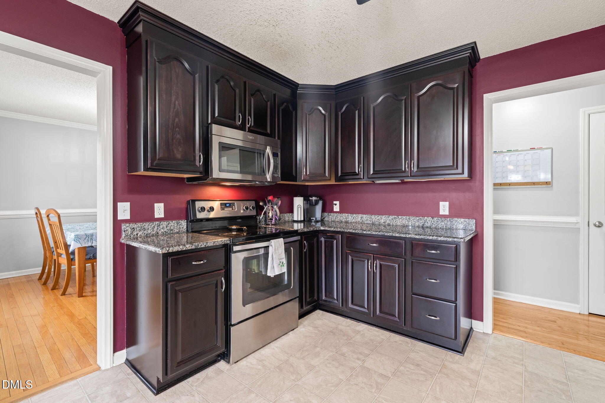 16 Saddle Ridge Drive Willow Spring, NC 27592 - Photo 15 of 57 a kitchen with stainless steel appliances granite countertop a stove and cabinets
