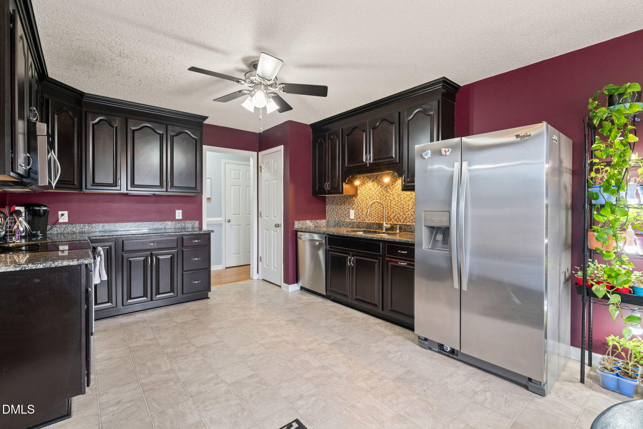 16 Saddle Ridge Drive Willow Spring, NC 27592 - Photo 18 of 57 a kitchen with stainless steel appliances a stove a refrigerator and a refrigerator