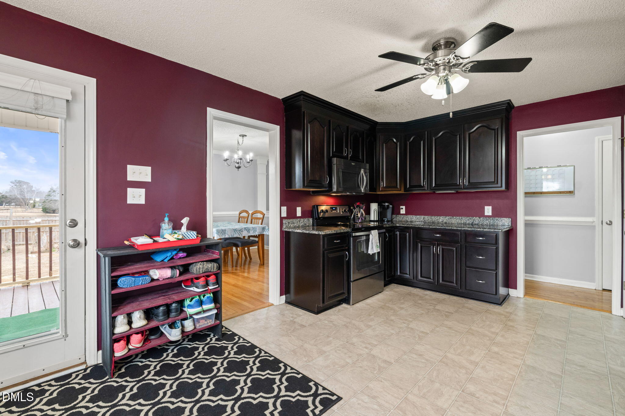 16 Saddle Ridge Drive Willow Spring, NC 27592 - Photo 19 of 57 a kitchen with stainless steel appliances kitchen island granite countertop a stove a sink and a microwave