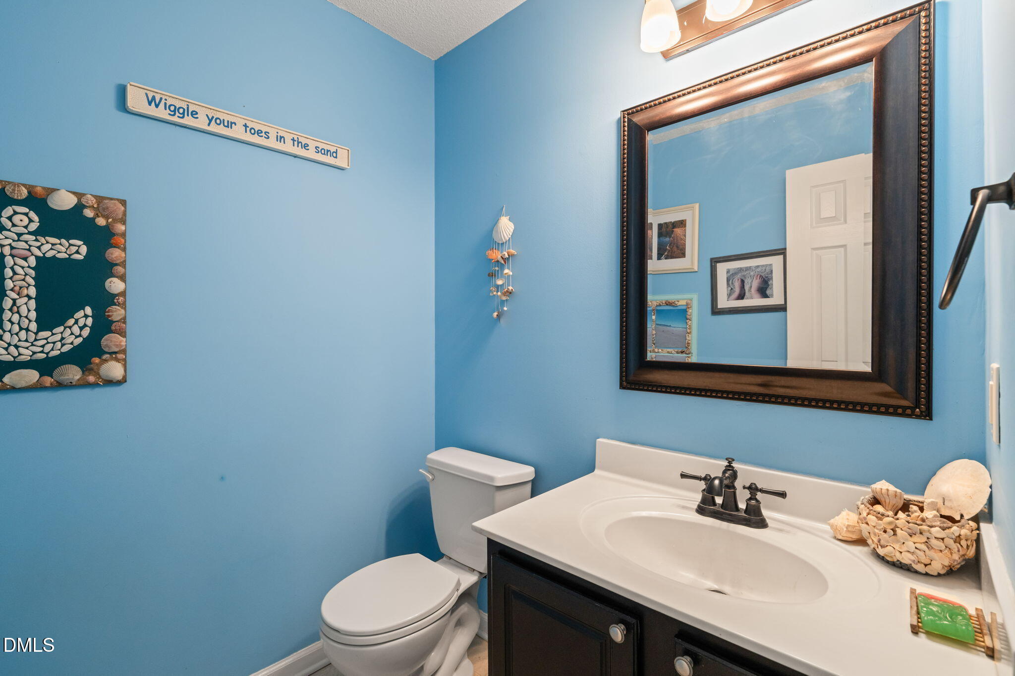 16 Saddle Ridge Drive Willow Spring, NC 27592 - Photo 21 of 57 a bathroom with a sink mirror and toilet