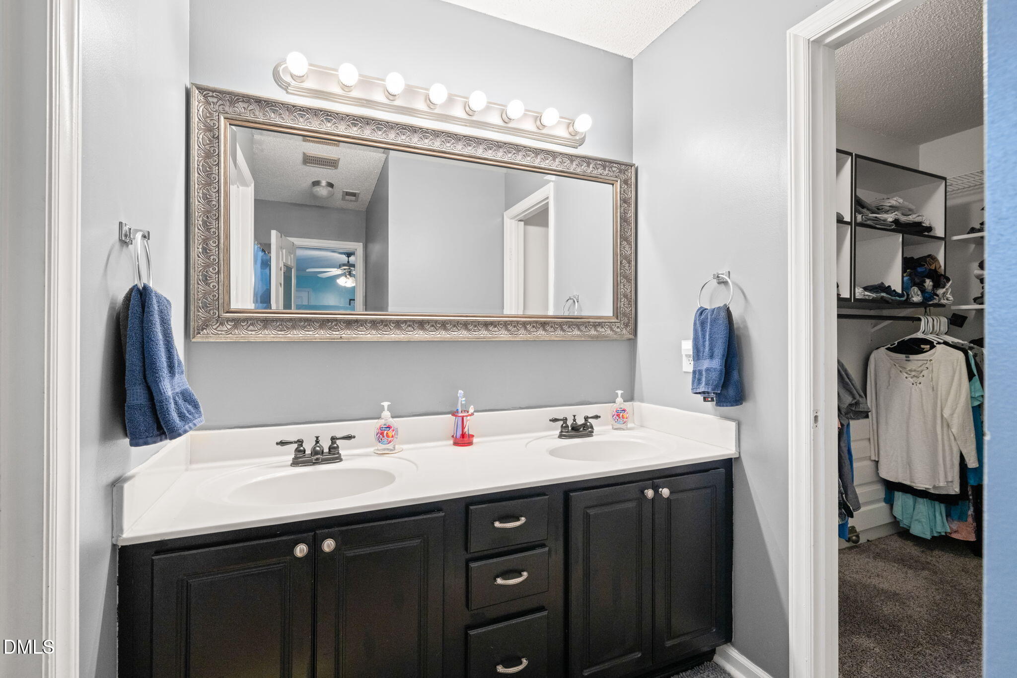 16 Saddle Ridge Drive Willow Spring, NC 27592 - Photo 26 of 57 a bathroom with a sink and a mirror