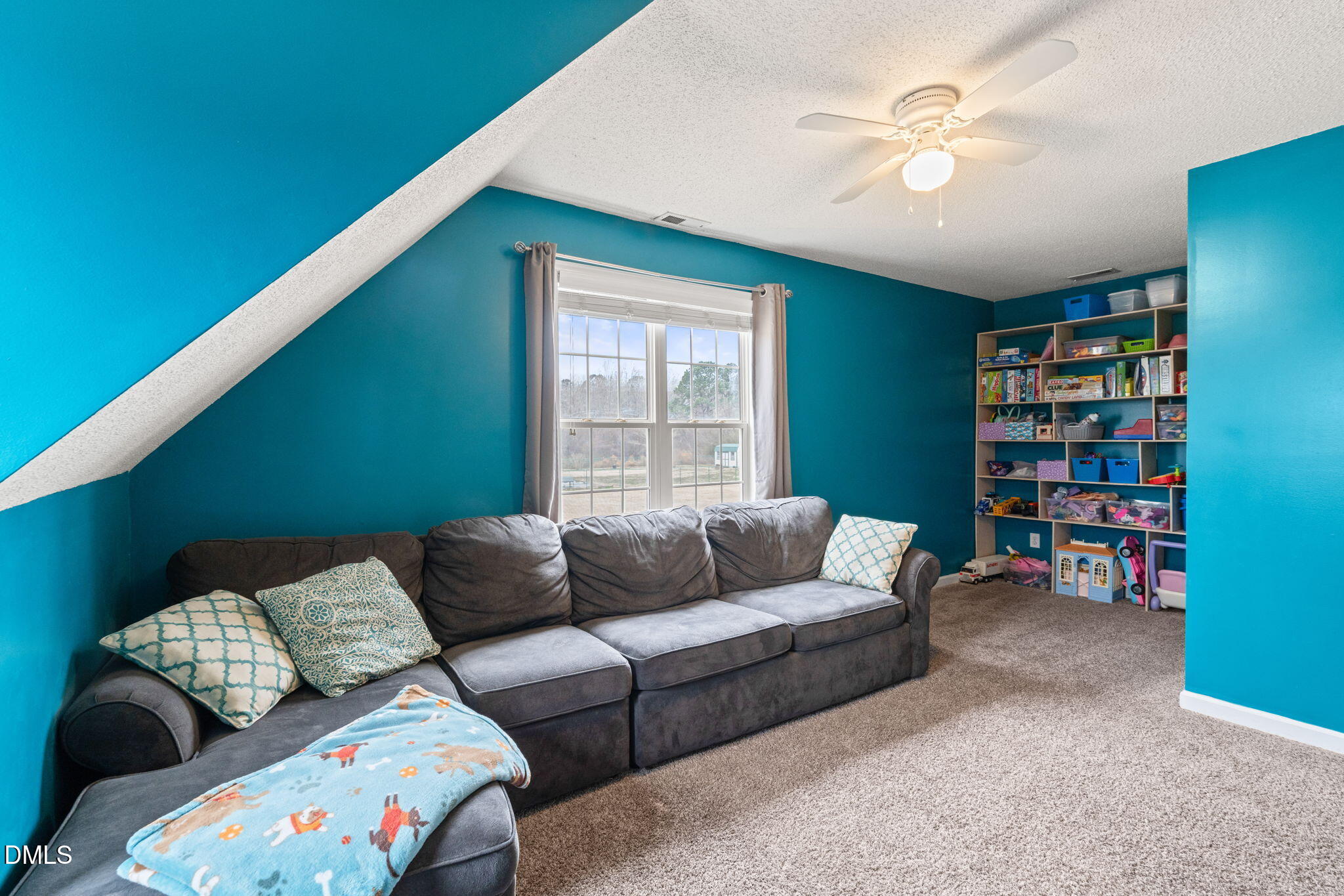 16 Saddle Ridge Drive Willow Spring, NC 27592 - Photo 38 of 57 a living room with furniture and a book shelf