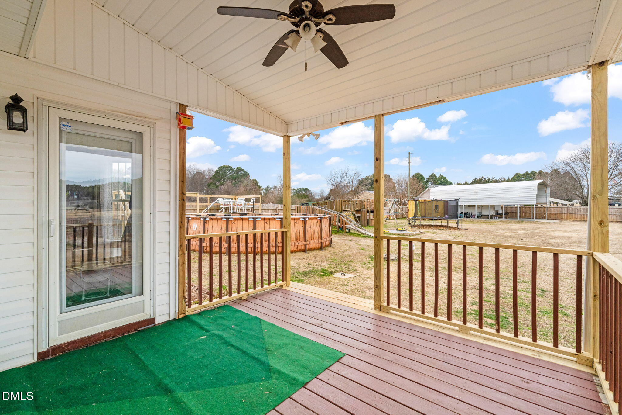 16 Saddle Ridge Drive Willow Spring, NC 27592 - Photo 41 of 57 a view of a porch with wooden floor and outdoor seating