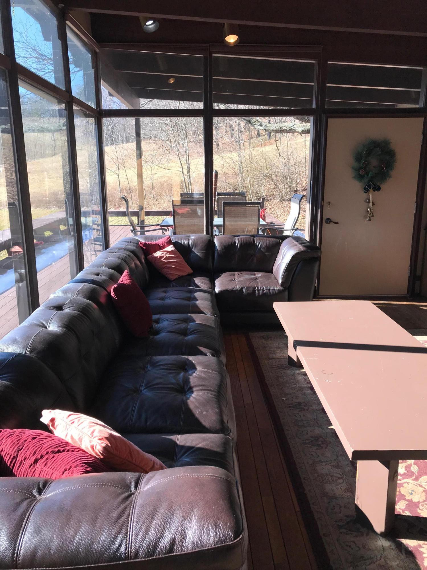 819 Wargo Road Union Dale, PA 18470 - Photo 7 of 49 a living room with furniture and a floor to ceiling window