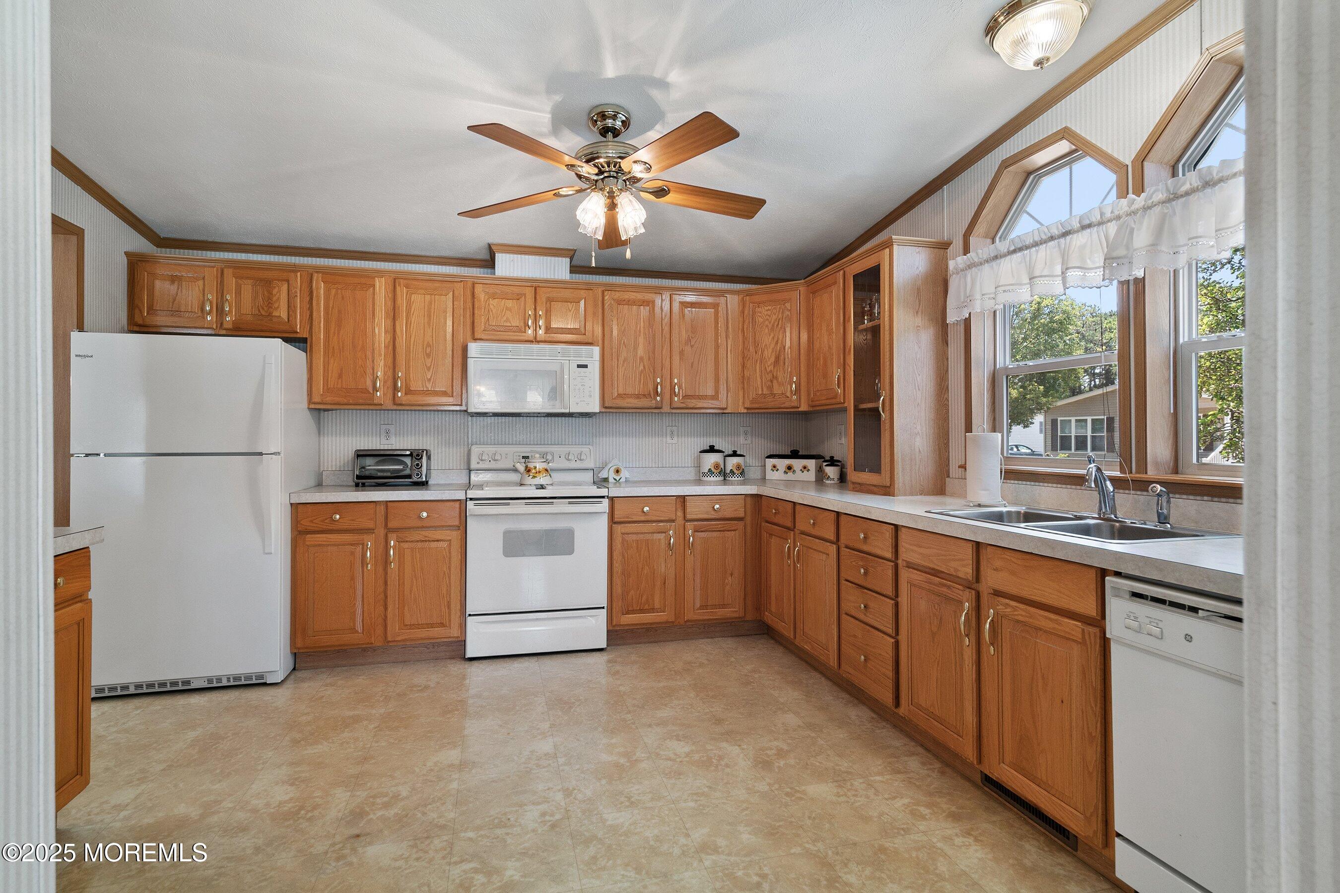 1104 Sycamore Court Whiting, NJ 08759 - Photo 14 of 55 a kitchen with a refrigerator a sink and cabinets