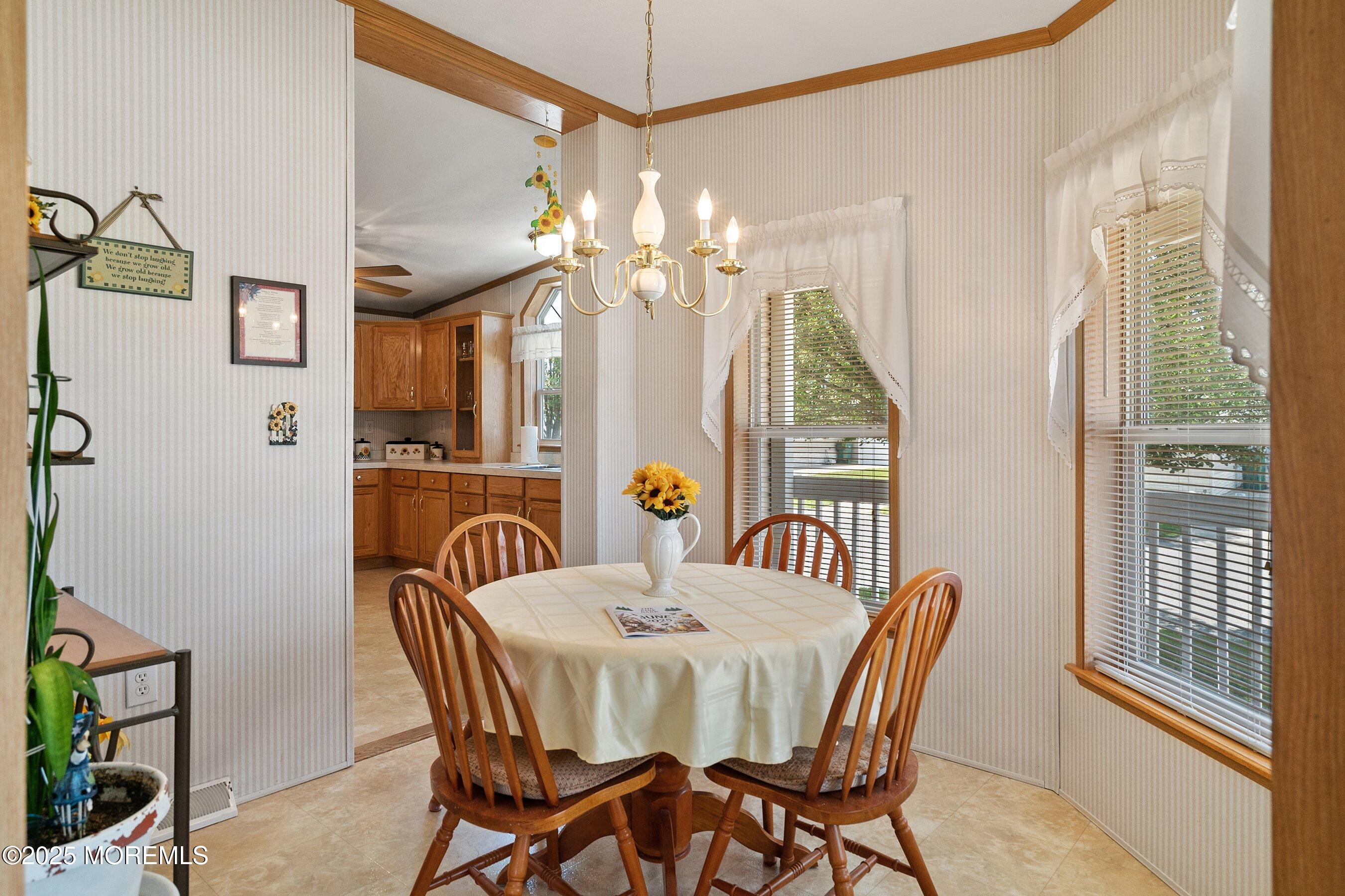 1104 Sycamore Court Whiting, NJ 08759 - Photo 18 of 55 a view of a dining room with furniture wooden floor and chandelier