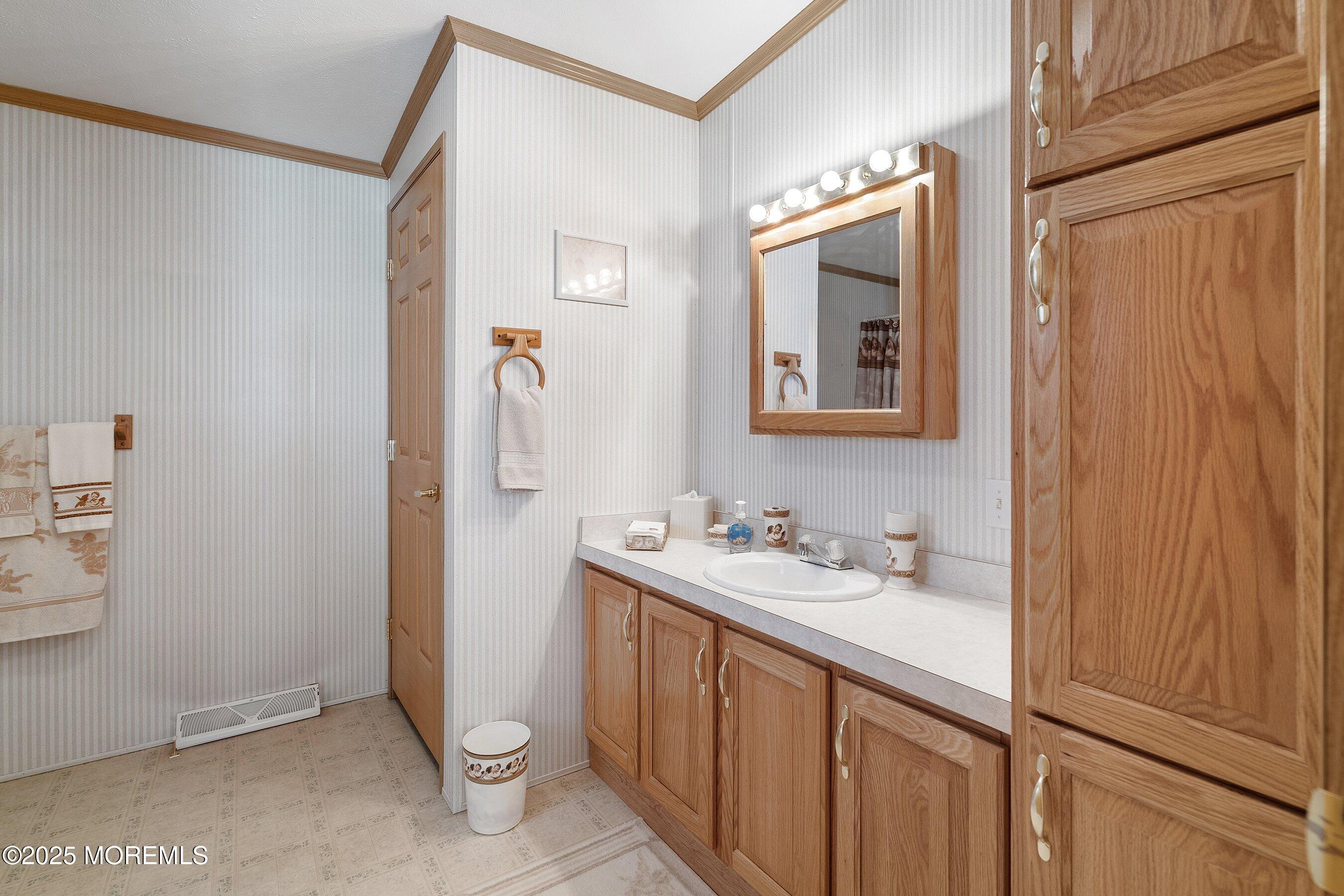 1104 Sycamore Court Whiting, NJ 08759 - Photo 22 of 55 a bathroom with a double vanity sink and mirror