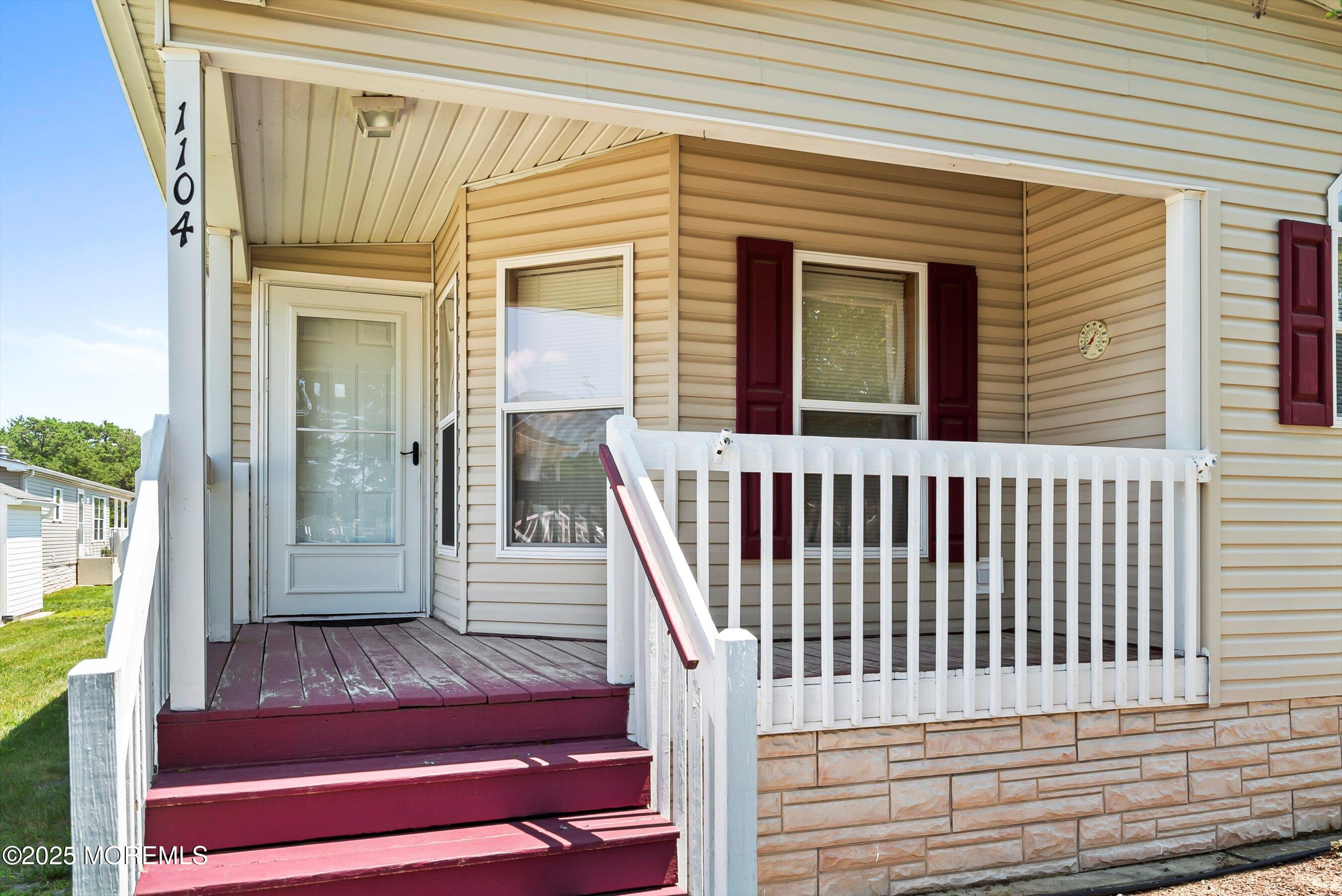 1104 Sycamore Court Whiting, NJ 08759 - Photo 7 of 55 a view of a balcony with wooden floor and stairs