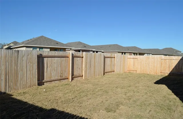 a view of a house with a garden and yard