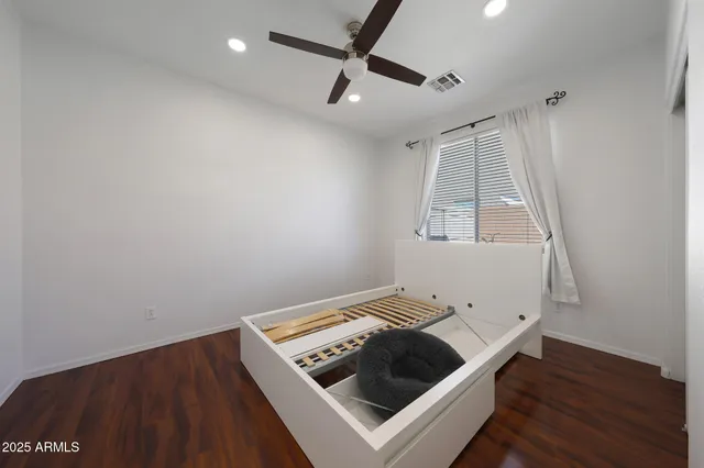 a living room with a bed furniture and a window