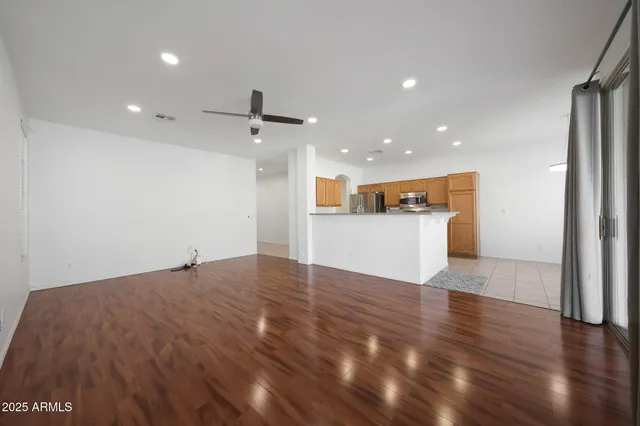 a view of a kitchen with a sink and wooden floor