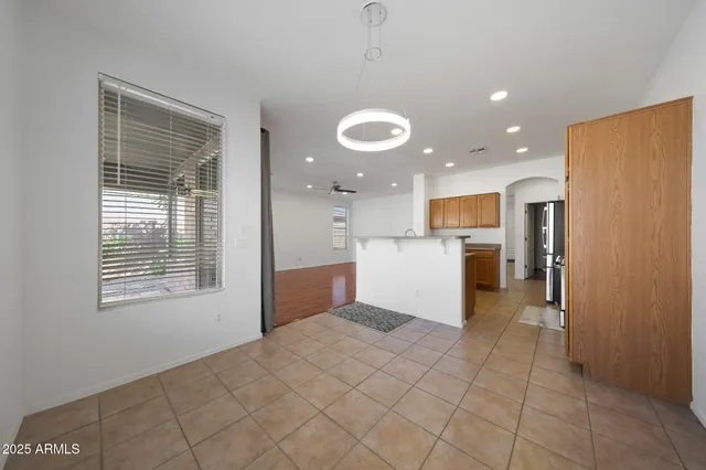 a view of kitchen with windows and refrigerator
