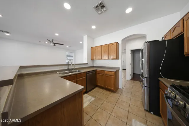 a kitchen with stainless steel appliances a refrigerator sink and stove
