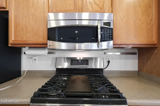 a stove top oven sitting inside of a kitchen