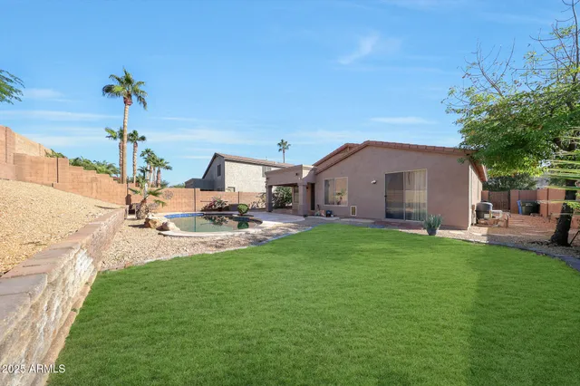 a view of a backyard with sitting area