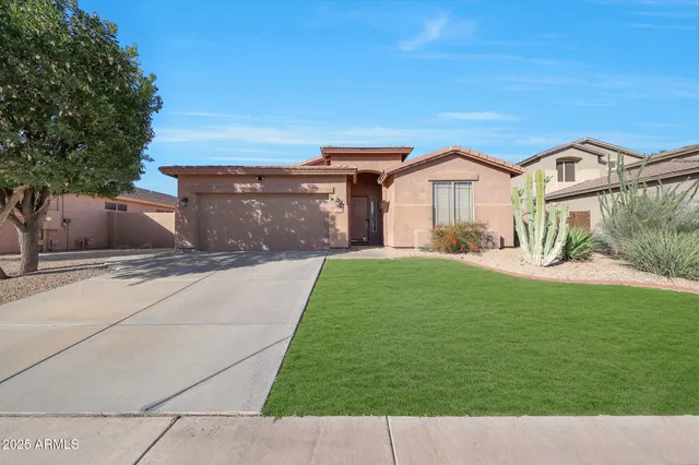 a front view of a house with a yard and garage