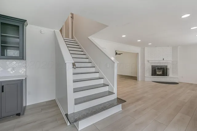 a view of a livingroom with wooden floor and stairs