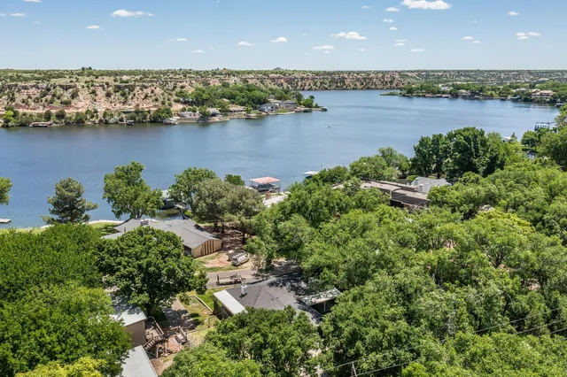 an aerial view of a city with lots of residential buildings lake and ocean view