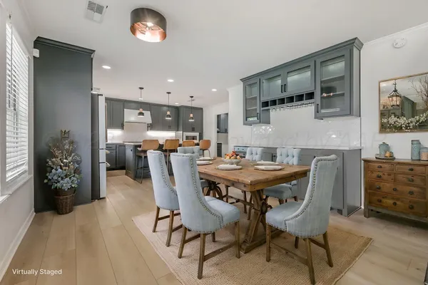 a living room with furniture a flat screen tv and kitchen view