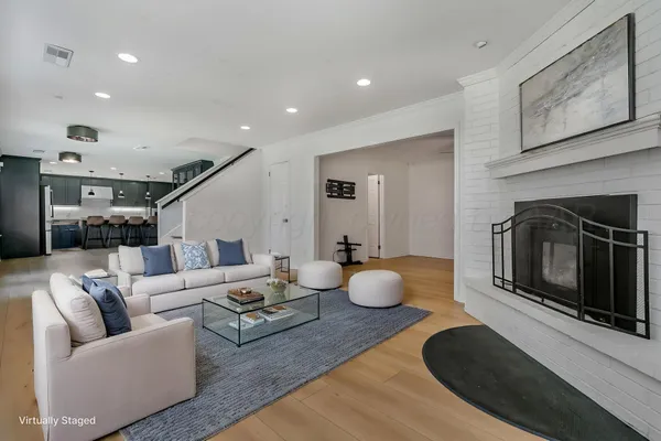a living room with furniture a flat screen tv and a fireplace