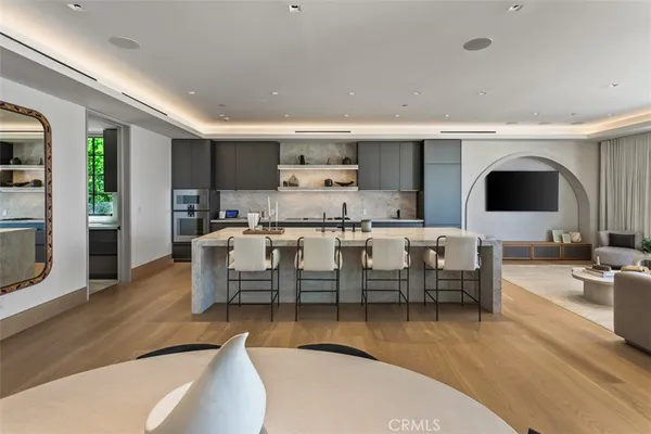 a large kitchen with stainless steel appliances granite countertop a lot of counter space and wooden floors