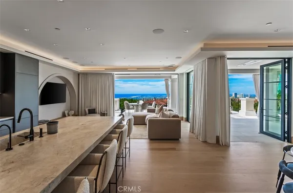 a living room with furniture and a floor to ceiling window