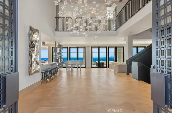 a dining hall with couches a dining table and chairs with a large window