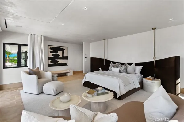 a bedroom with a large bed and a large window