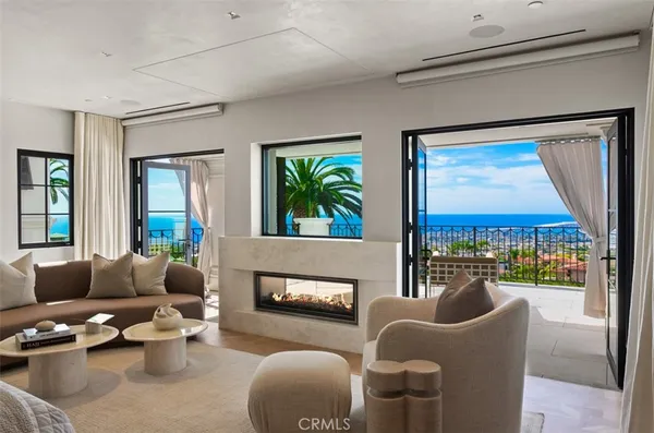 a living room with furniture a flat screen tv and a window