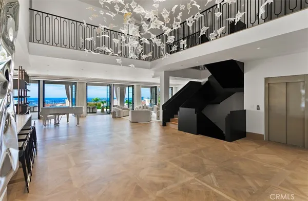 a living room with fireplace furniture and a large window