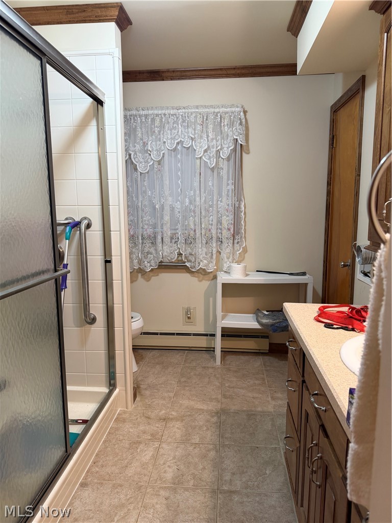 6063 East State Road Newcomerstown, OH 43832 - Photo 20 of 31 Tiled shower with sliding glass door, grab bar, neutral tile flooring, and wood-finish trim