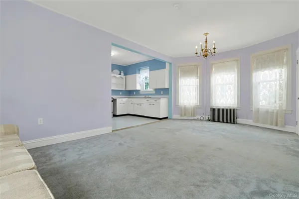 a living room with furniture and kitchen