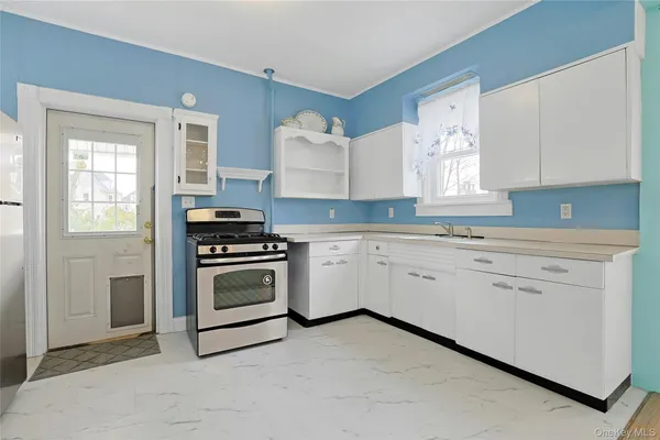 a view of a kitchen with sink cabinet and a window