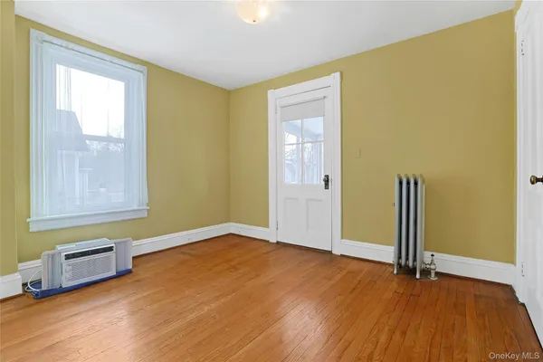a view of a large room with wooden floor and furniture