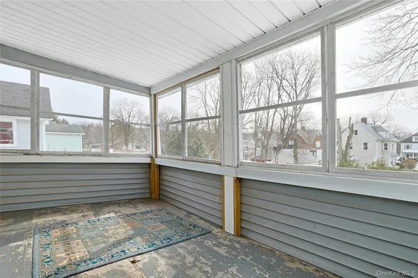 a bathroom with a granite countertop sink a toilet a mirror a bathtub and shower