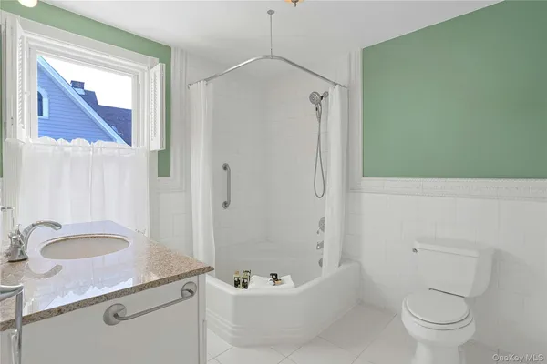 a bathroom with a sink a large mirror and a bathtub