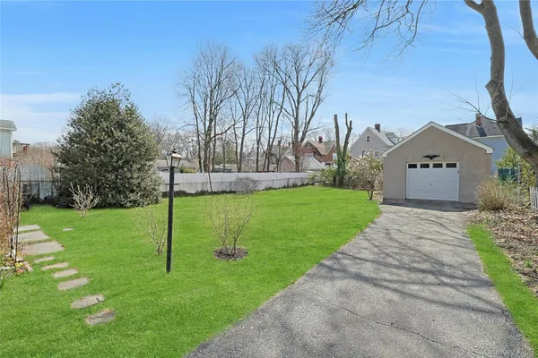 a view of house with yard and green space
