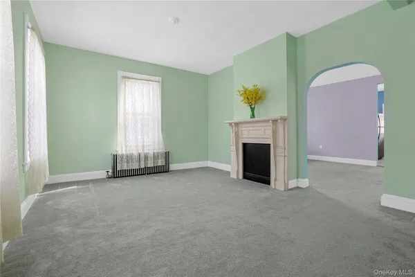 a view of a livingroom with a fireplace and window