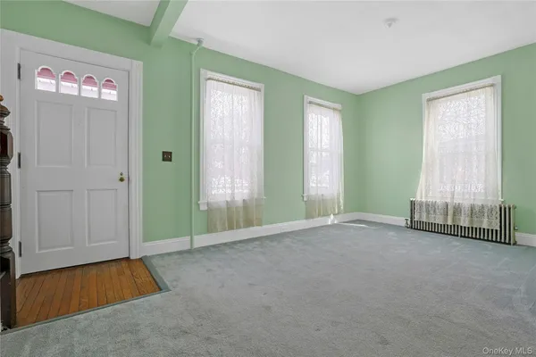 a view of an empty room with stairs