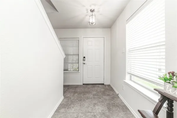 a view of entryway with window and hardwood floor