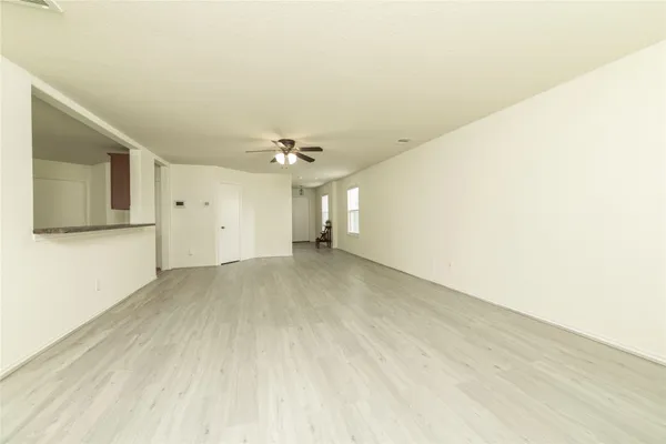 a view of empty room with wooden floor