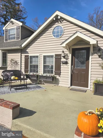 a view of a house with pool and chairs