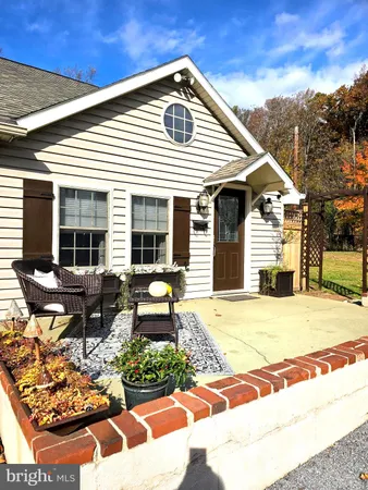 a view of a patio with table and chairs and wooden fence