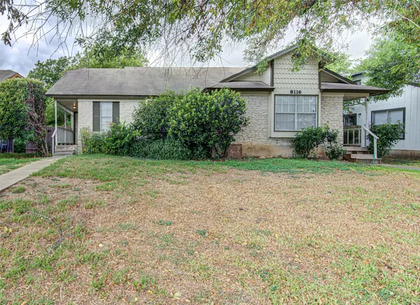 a view of a house with a yard and plants