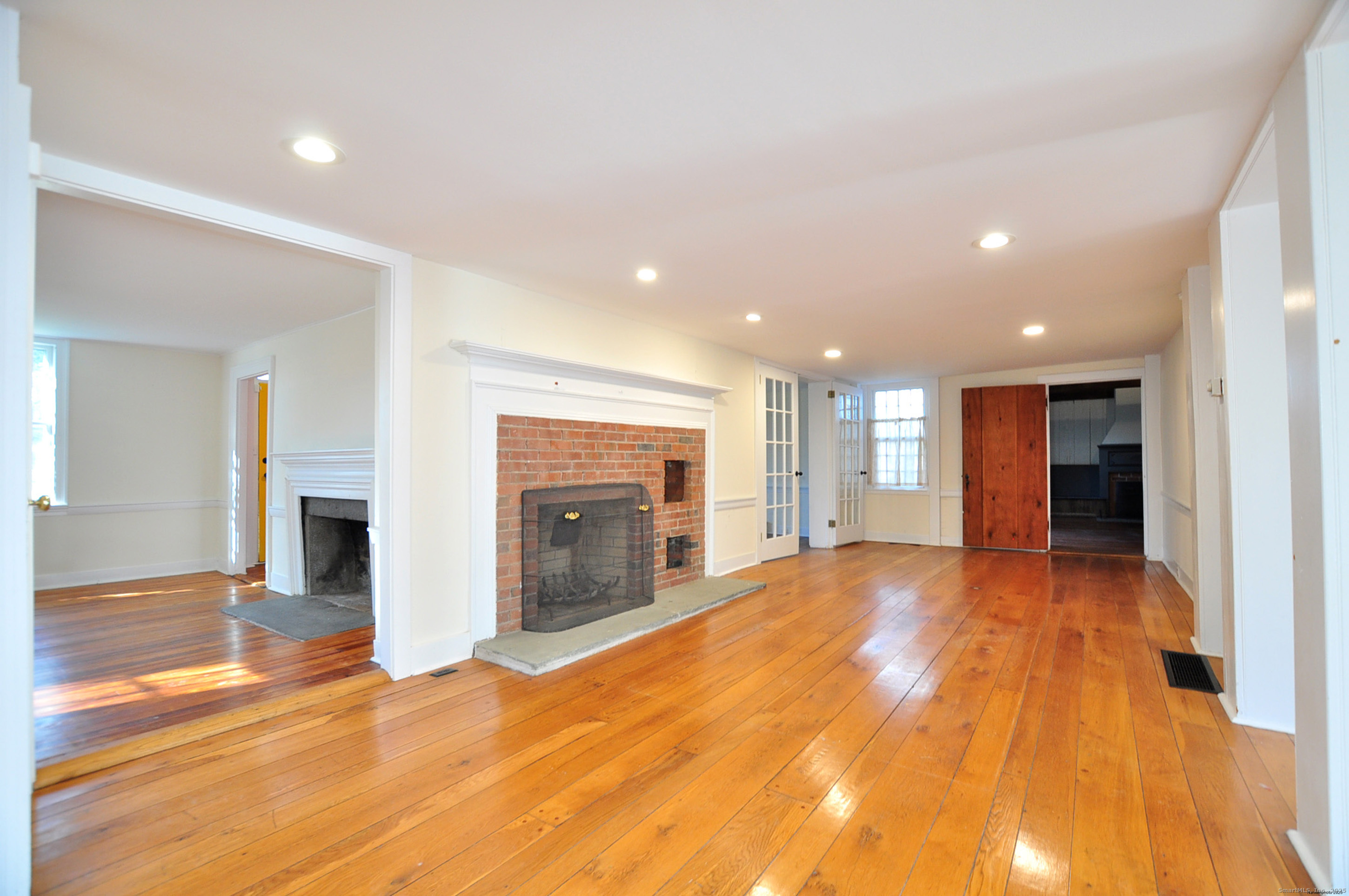 11 West Chestnut Hill Road Litchfield, CT 06759 - Photo 14 of 39 a view of an empty room with a fireplace and a window