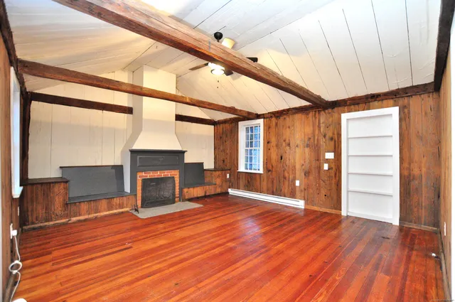 a view of a livingroom with wooden floor and staircase