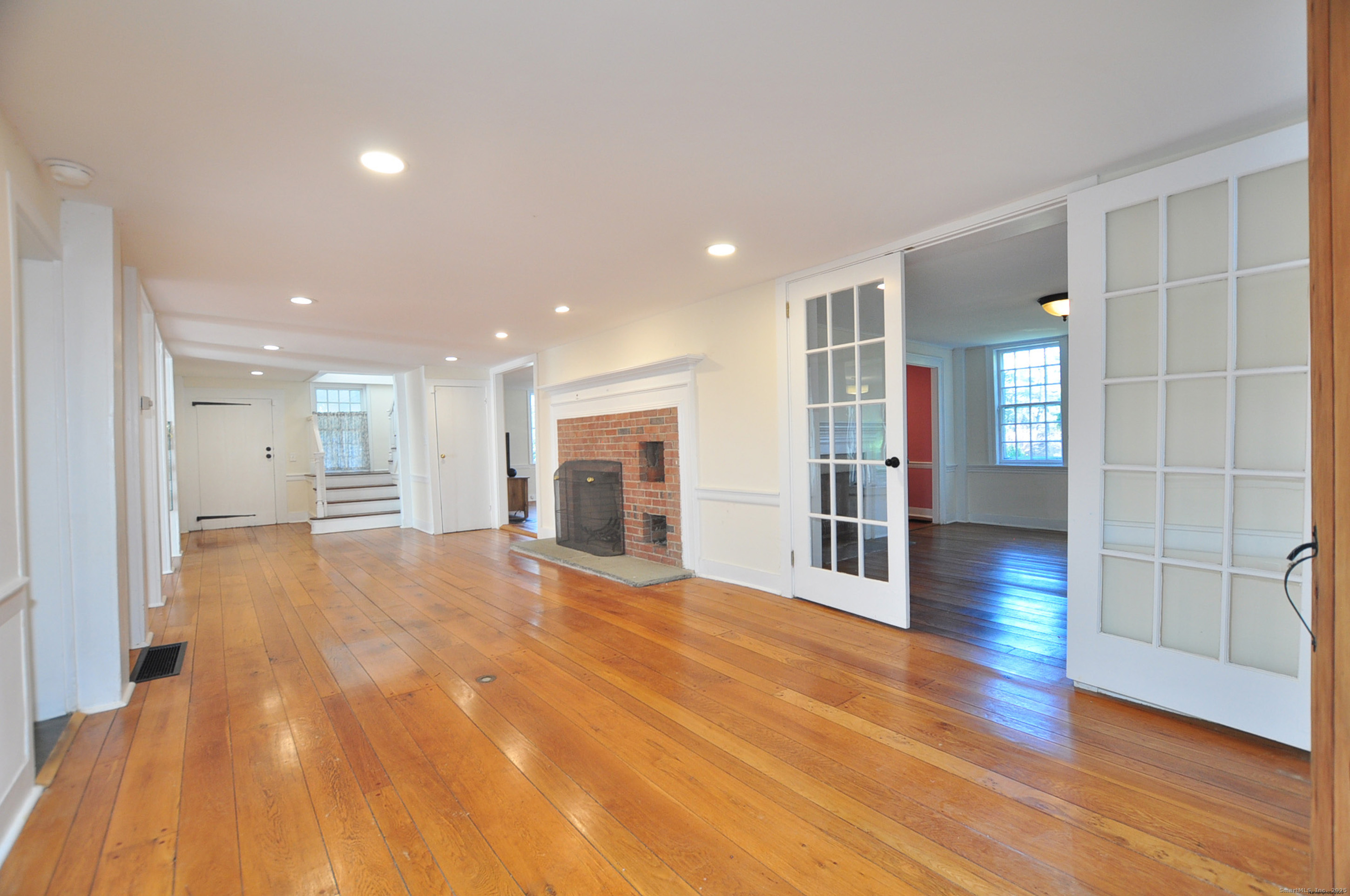 11 West Chestnut Hill Road Litchfield, CT 06759 - Photo 2 of 39 a view of an empty room with wooden floor and windows